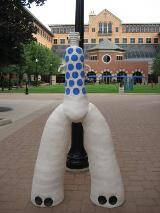 Abstract sculpture with what appears to be two legs and blue and black spots in areas.